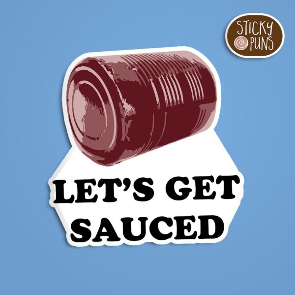A pun sticker with the phrase 'Let's Get SAUCED' written on a can of cranberry sauce.