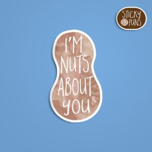 A pun sticker with the phrase 'I'm NUTS about you' written on a peanut.  Sticker is on a blue background with a sticky puns logo in the top right corner.