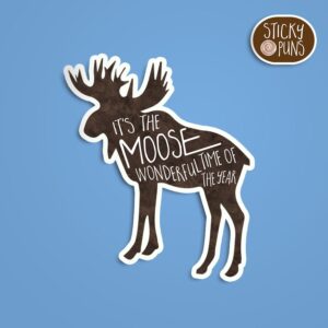 A pun sticker with the phrase 'It's the MOOSE wonderful time of the year' featuring a jolly moose. Sticker is on a blue background with a sticky puns logo in the top right corner.