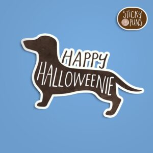 A pun sticker with the phrase 'Happy HalloWEENIE' featuring a festive dachshund. Sticker is on a blue background with a sticky puns logo in the top right corner.