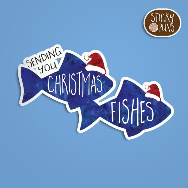 A pun sticker featuring a couple of blue fish wearing Santa hats with the phrase 'Sending you Christmas fishes.  Sticker is on a blue background with a sticky puns logo in the top right corner.