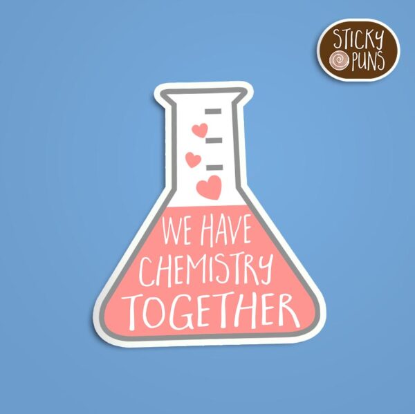 A pun sticker with the phrase 'We have chemistry together' written on a beaker