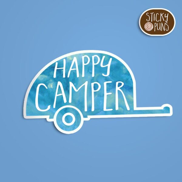 A pun sticker featuring the phrase 'Happy Camper' written on a portable camping trailer. Sticker is on a blue background with a sticky puns logo in the top right corner.