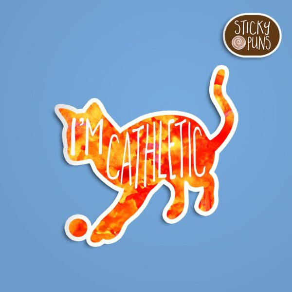 A pun sticker with the phrase 'I'm CAThletic' featuring an athletic cat. Sticker is on a blue background with a sticky puns logo in the top right corner.