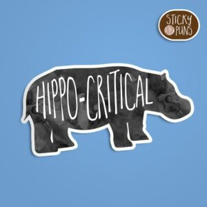 A pun sticker with the phrase 'hippo critical.' Sticker is on a blue background with a sticky puns logo in the top right corner.