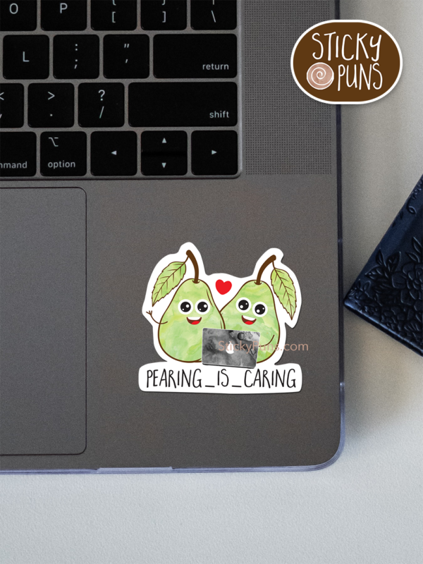 Pearing is Caring pun sticker shown stuck on a laptop