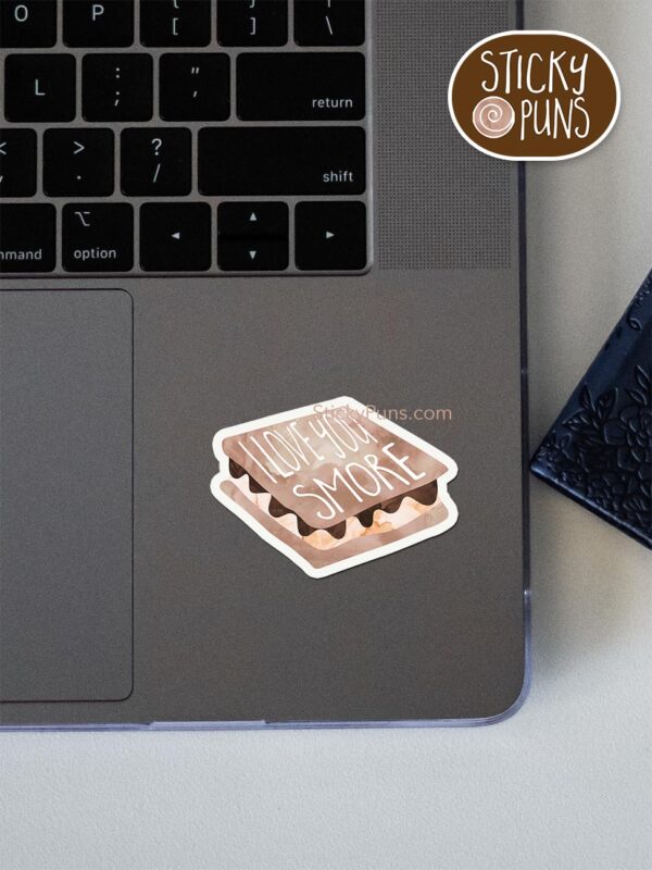 I love you smore pun sticker shown stuck on a laptop