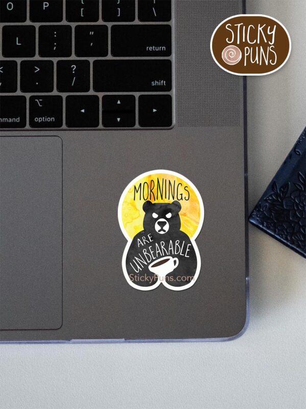 Mornings are unBEARable pun sticker shown stuck on a laptop