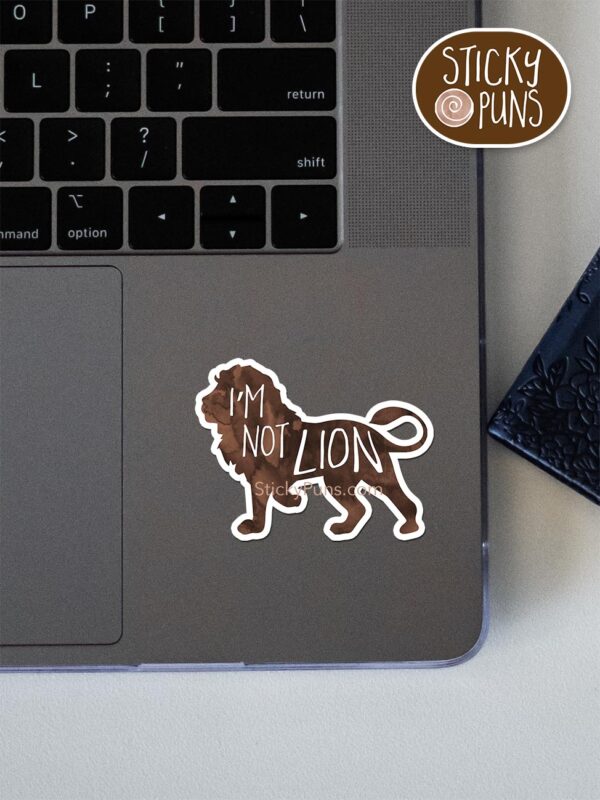 I'm not LION pun sticker shown stuck on a laptop