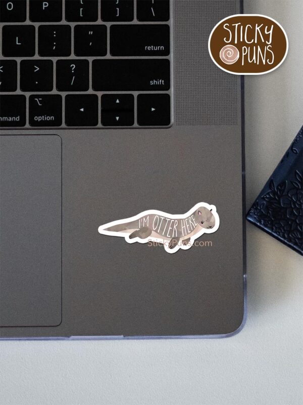 I'm otter here pun sticker shown stuck on a laptop