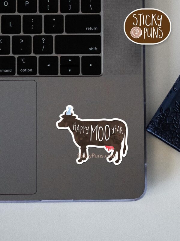 Happy MOO Year pun sticker shown stuck on a laptop