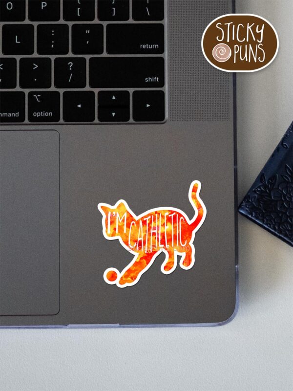 I'm CAThletic pun sticker shown stuck on a laptop