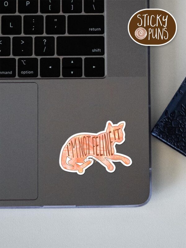 I'm not FELINE it - cute cat pun sticker shown stuck on a laptop