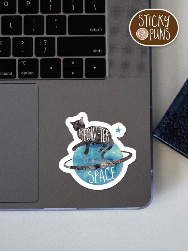 MEOWter Space pun sticker shown stuck on a laptop