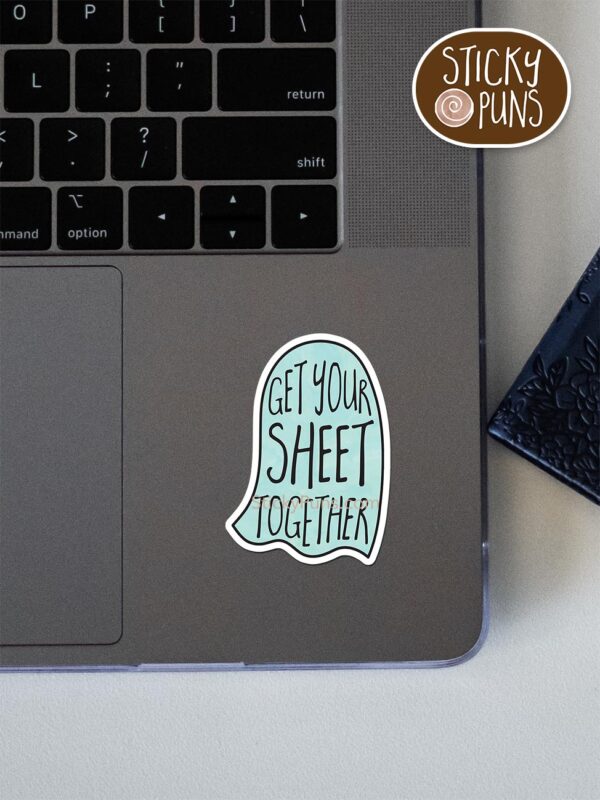 Get your SHEET together pun sticker shown stuck on a laptop