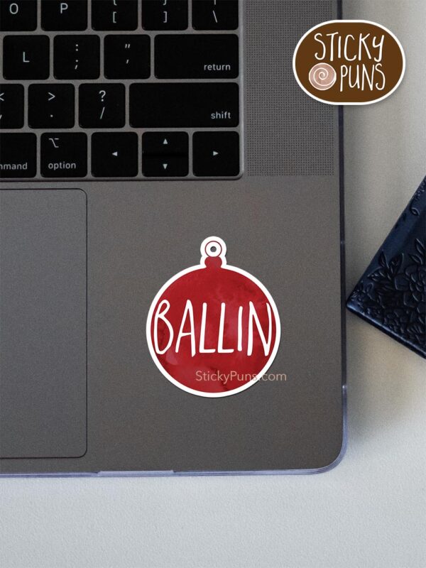 ballin christmas pun sticker shown stuck on a laptop