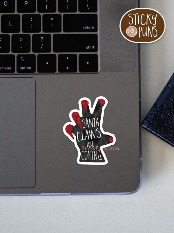 Santa CLAWS Are Coming pun sticker shown stuck on a laptop