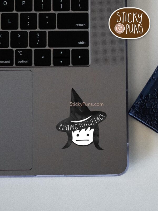 Resting WITCH face pun sticker shown stuck on a laptop