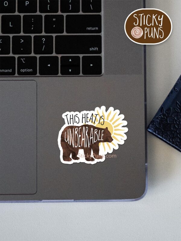 This heat is unBEARable pun sticker shown stuck on a laptop