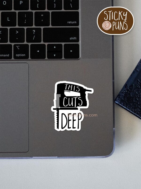 This cuts deep pun sticker shown stuck on a laptop