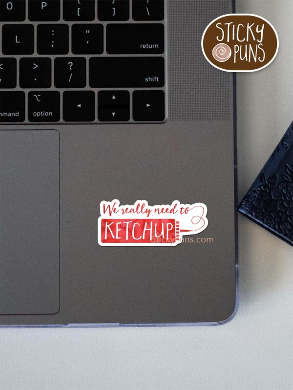 Add a tasty twist to your relationships and connections with our 'We Really Need to KETCHUP' ketchup pun sticker. Stick it on your notes or belongings to remind everyone that it's time to catch up and RELISH the moments together. It's a 'saucy' way to stay connected! pun sticker shown stuck on a laptop