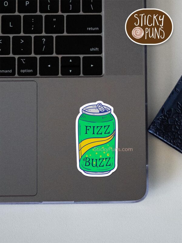 Fizz Buzz' programming pun sticker shown stuck on a laptop