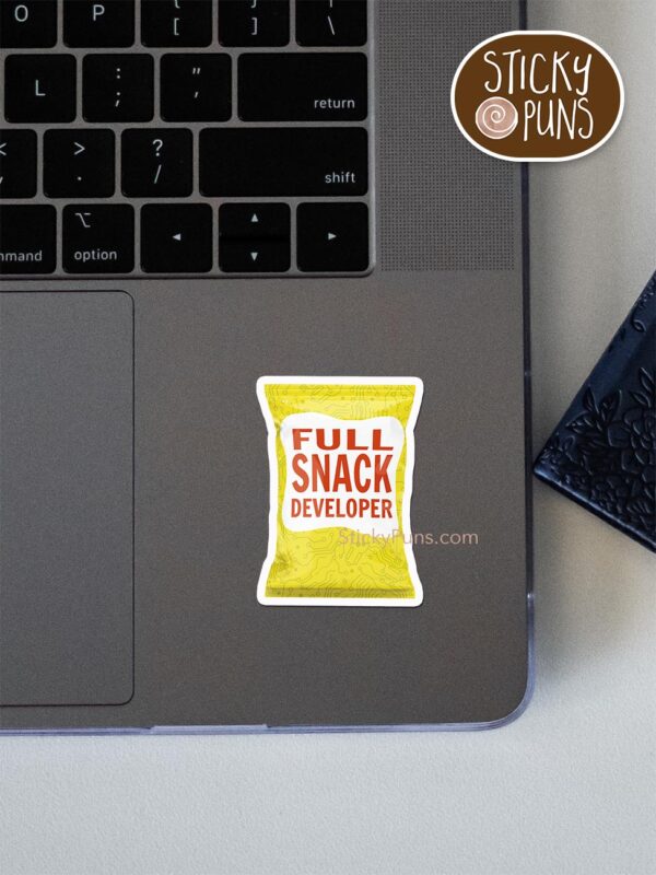 full SNACK developer pun sticker shown stuck on a laptop