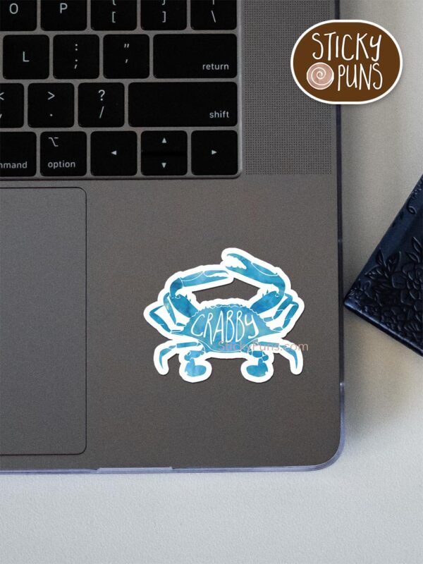 crabby pun sticker shown stuck on a laptop