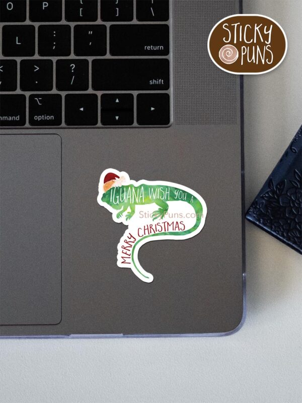 iguana wish you a merry christmas pun sticker shown stuck on a laptop