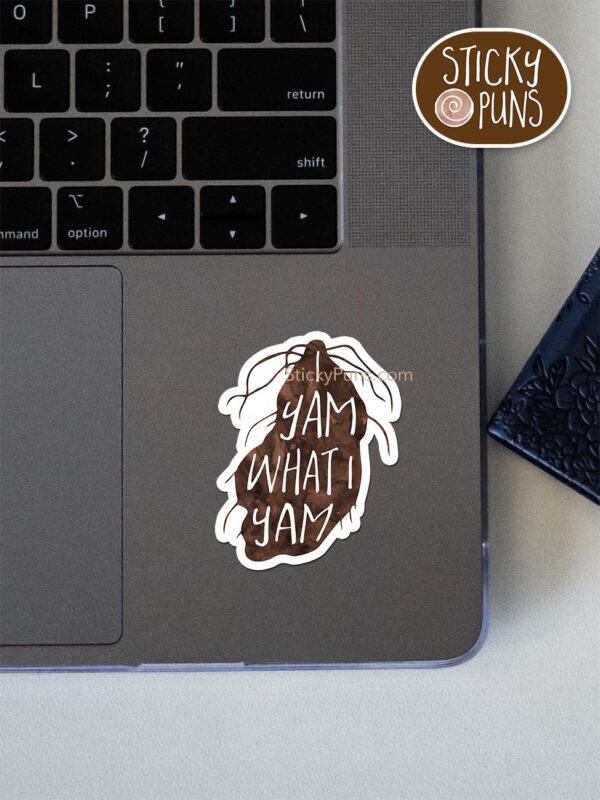 I yam what I yam pun sticker shown stuck on a laptop