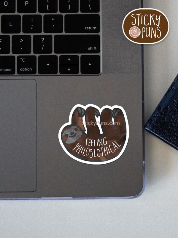 Feeling philoSLOTHical pun sticker shown stuck on a laptop