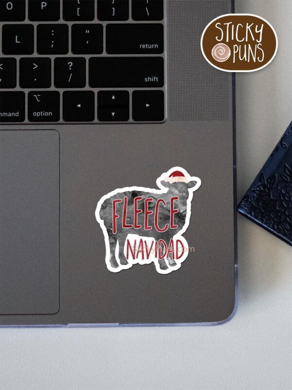 fleece navidad pun sticker shown stuck on a laptop