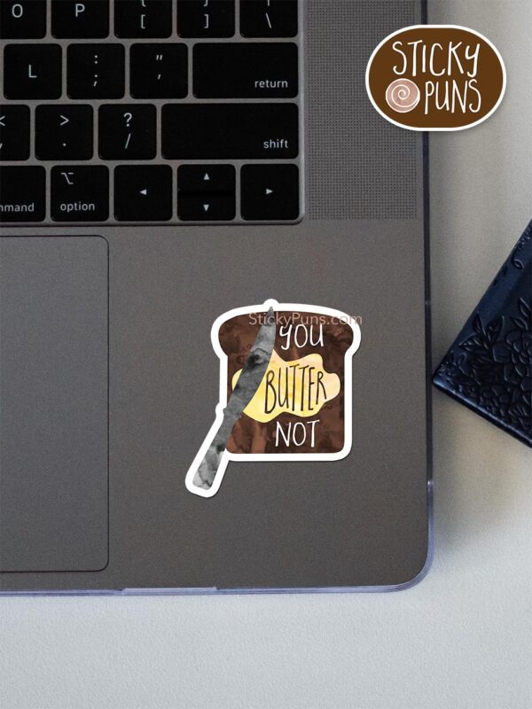 you butter not pun sticker shown stuck on a laptop