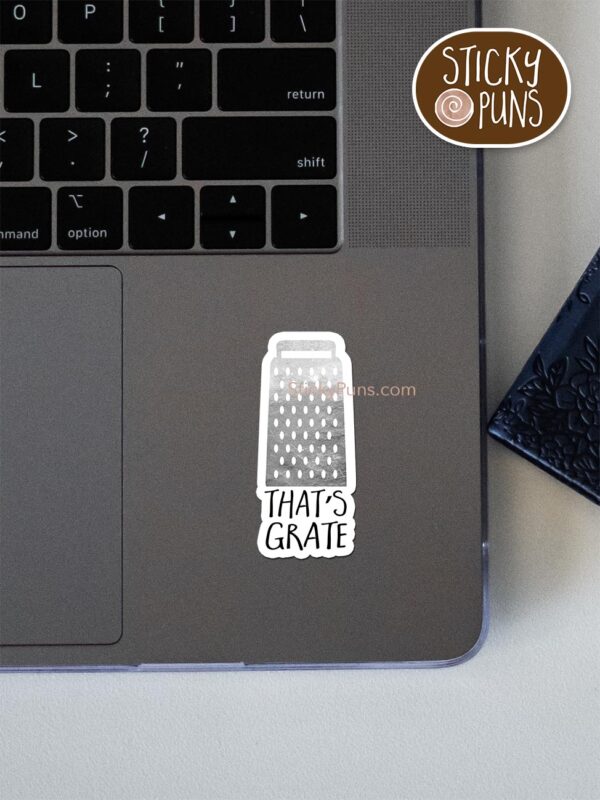 that's grate pun sticker shown stuck on a laptop