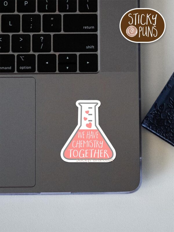 we have chemistry together pun sticker shown stuck on a laptop