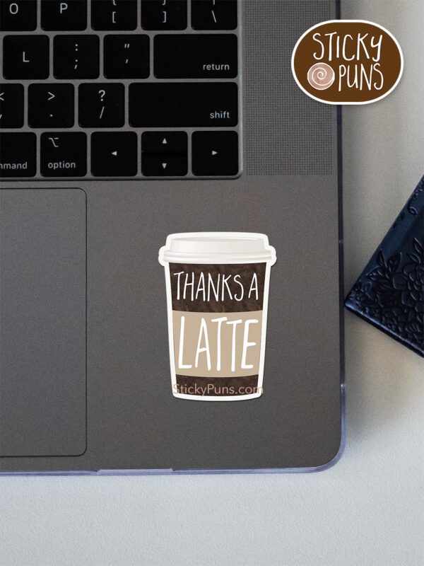 thanks a latte pun sticker shown stuck on a laptop