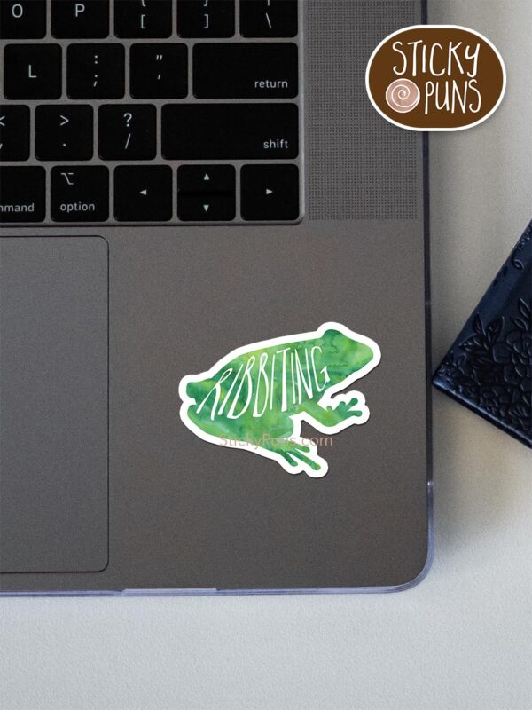 ribbiting frog pun sticker shown stuck on a laptop