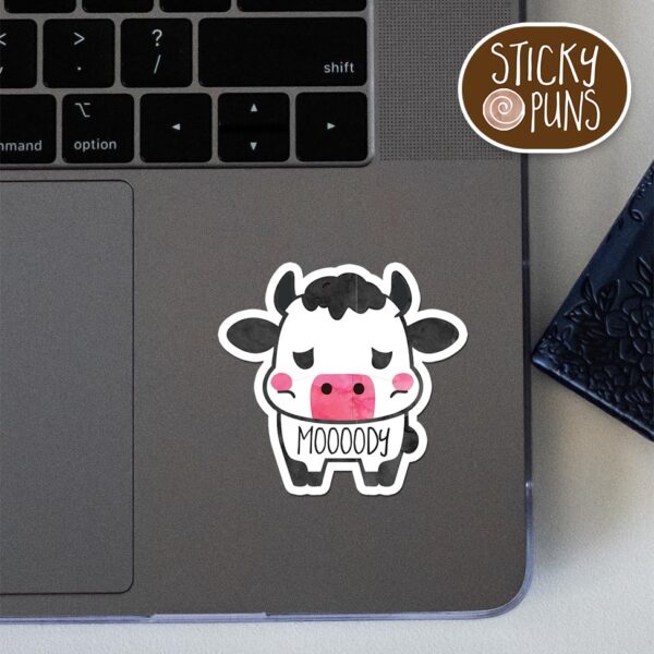 funny cow pun sticker on a laptop