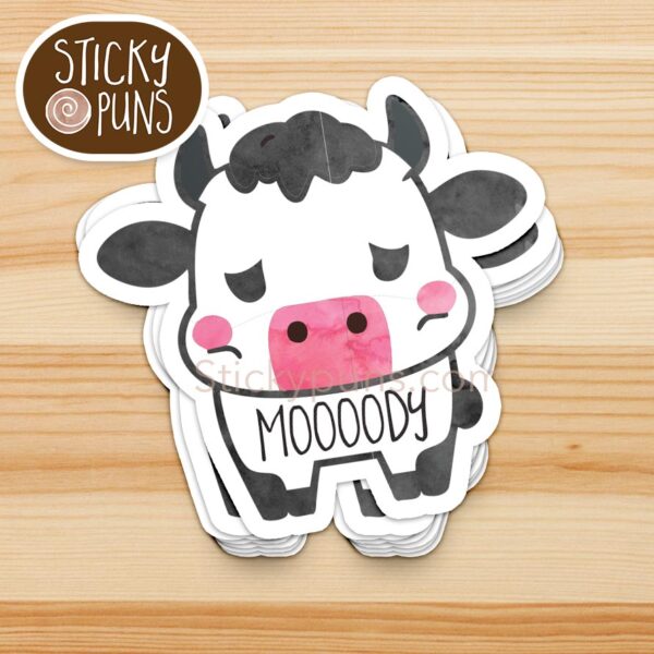 stack of funny cow pun stickers - a cute cow with the word "moooody" written on it