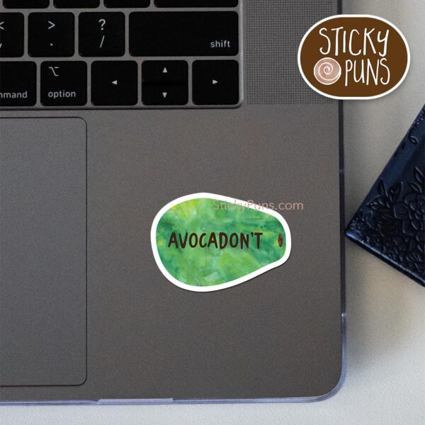 Funny green avocado-shaped sticker with brown text saying “Avocadon’t”