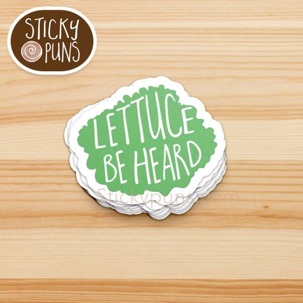 Leafy green sticker with the pun “Lettuce Be Heard” for witty, wordplay enthusiasts.